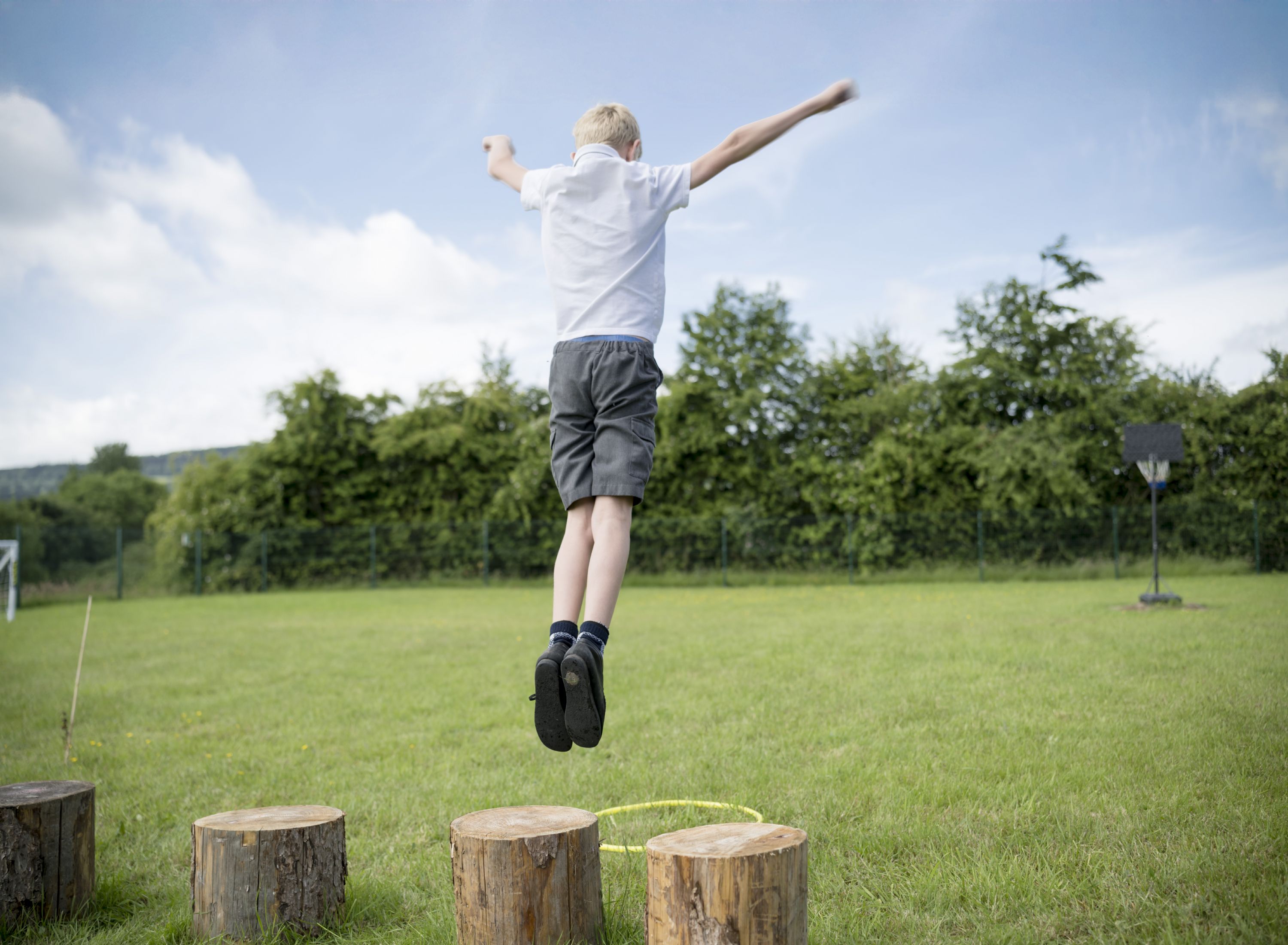 Image of young person in climbing gear looking out over hills