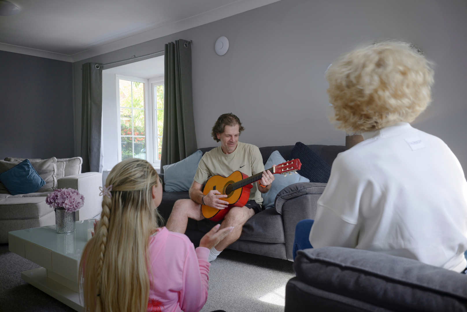 Image of a carer pointing toy wand at camera