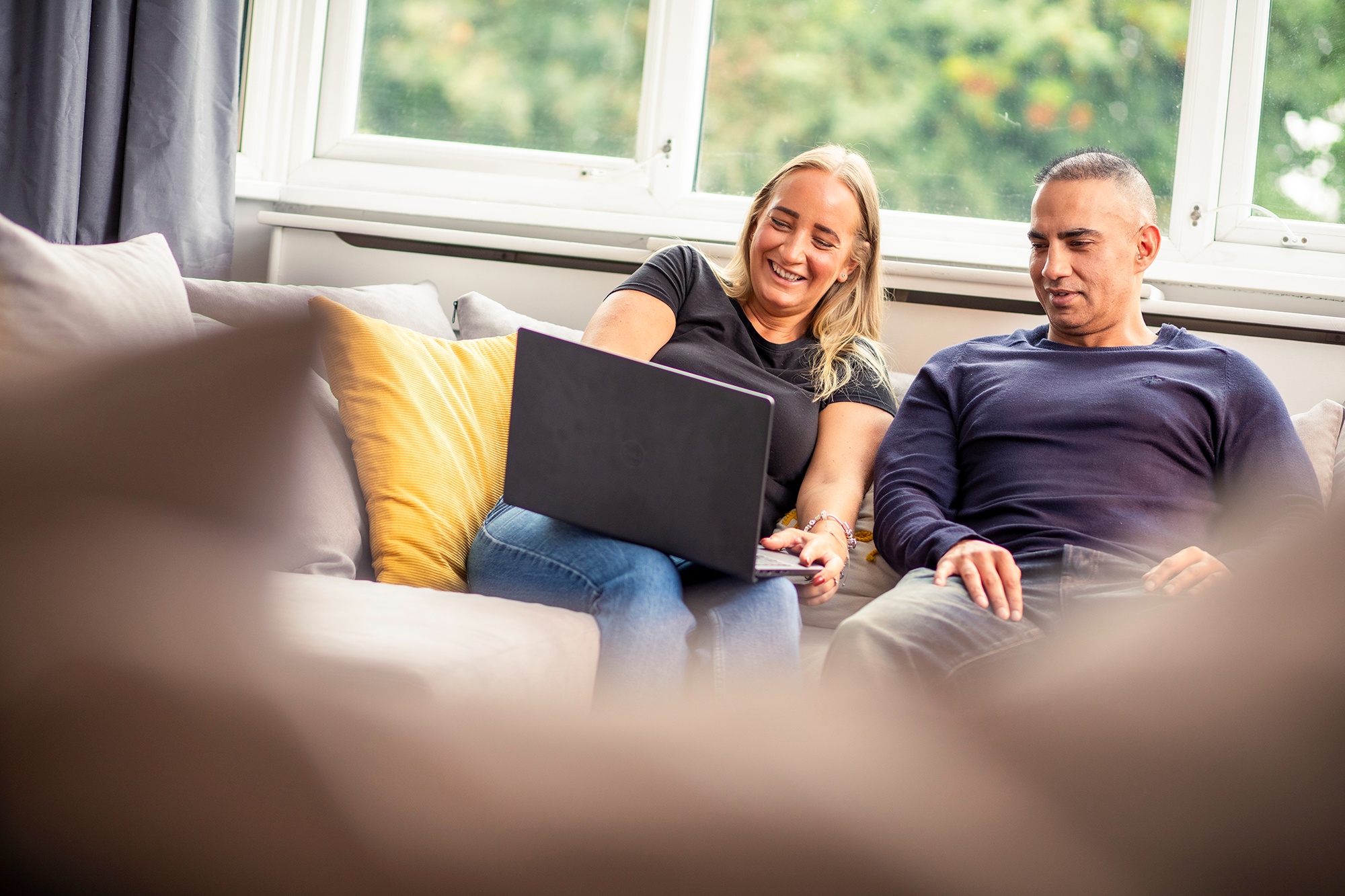 Image of two carers looking at a laptop